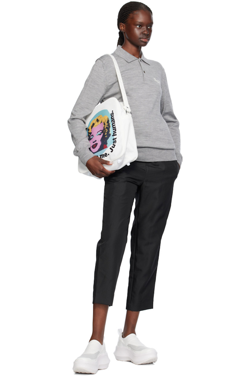 Knit wool polo.

· Rib knit spread collar, hem, and cuffs
· Two-button placket
· Intarsia text at chest

Supplier color: Gray
