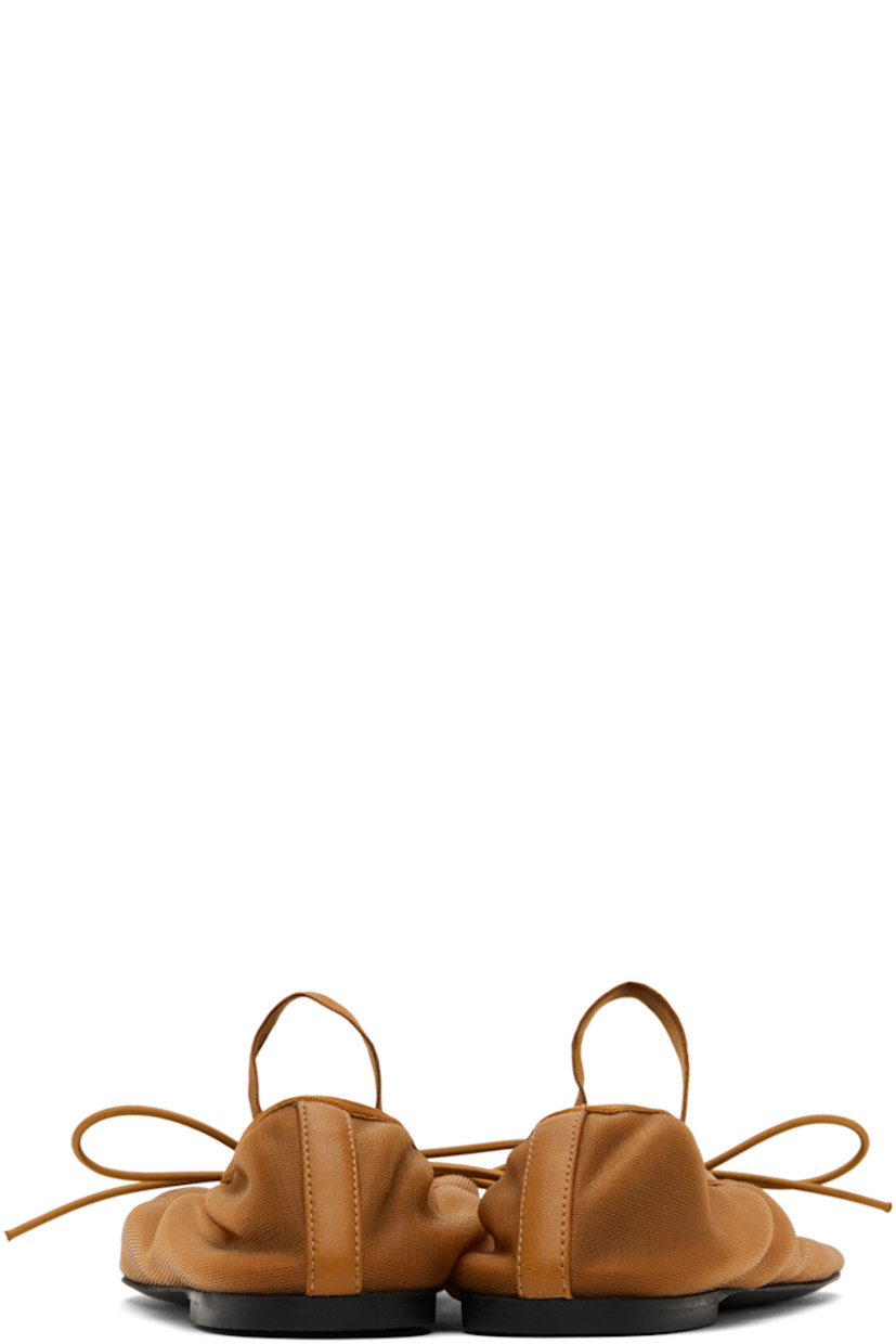 Semi-sheer nylon mesh Mary Jane-style ballerina flats in brown.

· Self-tie bow accent at vamp
· Elasticized strap at vamp
· Elasticized collar
· Logo embossed at buffed leather footbed
· Rubber sole

Supplier color: Light/Pastel brown