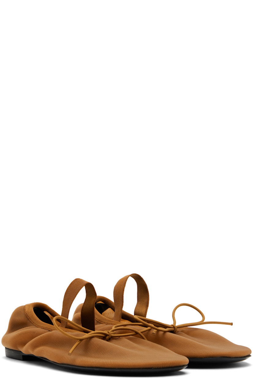 Semi-sheer nylon mesh Mary Jane-style ballerina flats in brown.

· Self-tie bow accent at vamp
· Elasticized strap at vamp
· Elasticized collar
· Logo embossed at buffed leather footbed
· Rubber sole

Supplier color: Light/Pastel brown