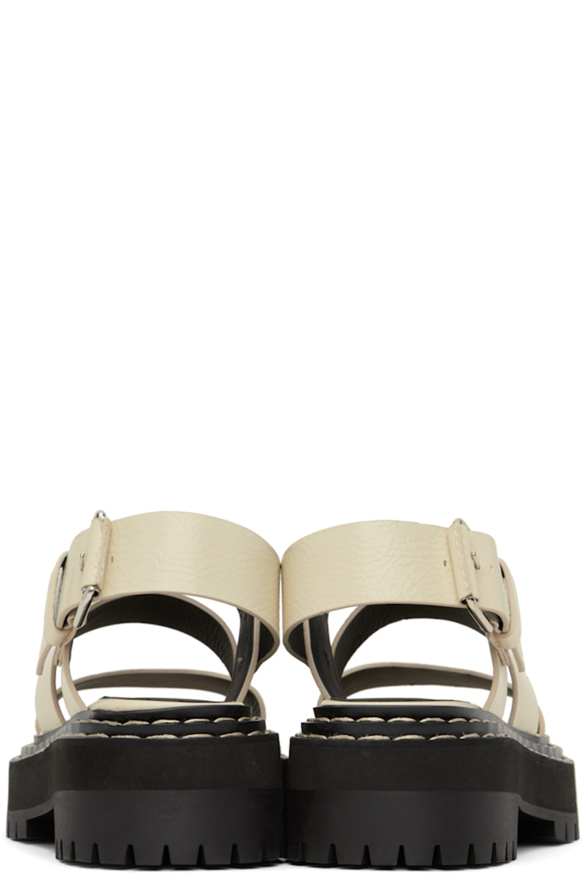 Grained calfskin sandals in off-white. 

· Straps at vamp
· Pin-buckle ankle strap
· Logo printed at leather footbed
· Topstitching at tiered welt
· Foam rubber platform midsole
· Lug rubber sole
· Platform: H1.25"
· Heel: H1.75"

Supplier color: Natural