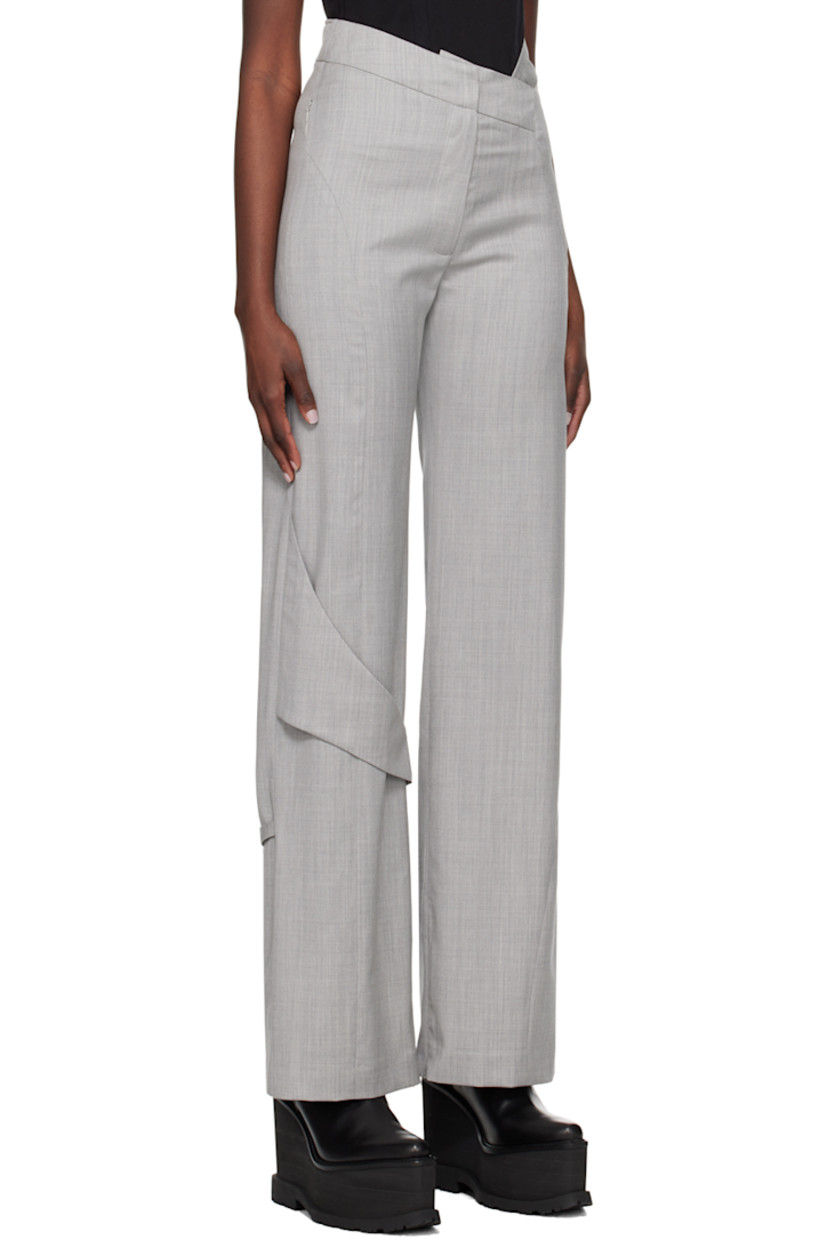 Wool delaine trousers.

· Strap at asymmetric waistband
· Two-pocket styling
· Zip-fly
· Fixed strap at front and back knee
· Concealed zip vent at cuffs

Supplier color: Light grey