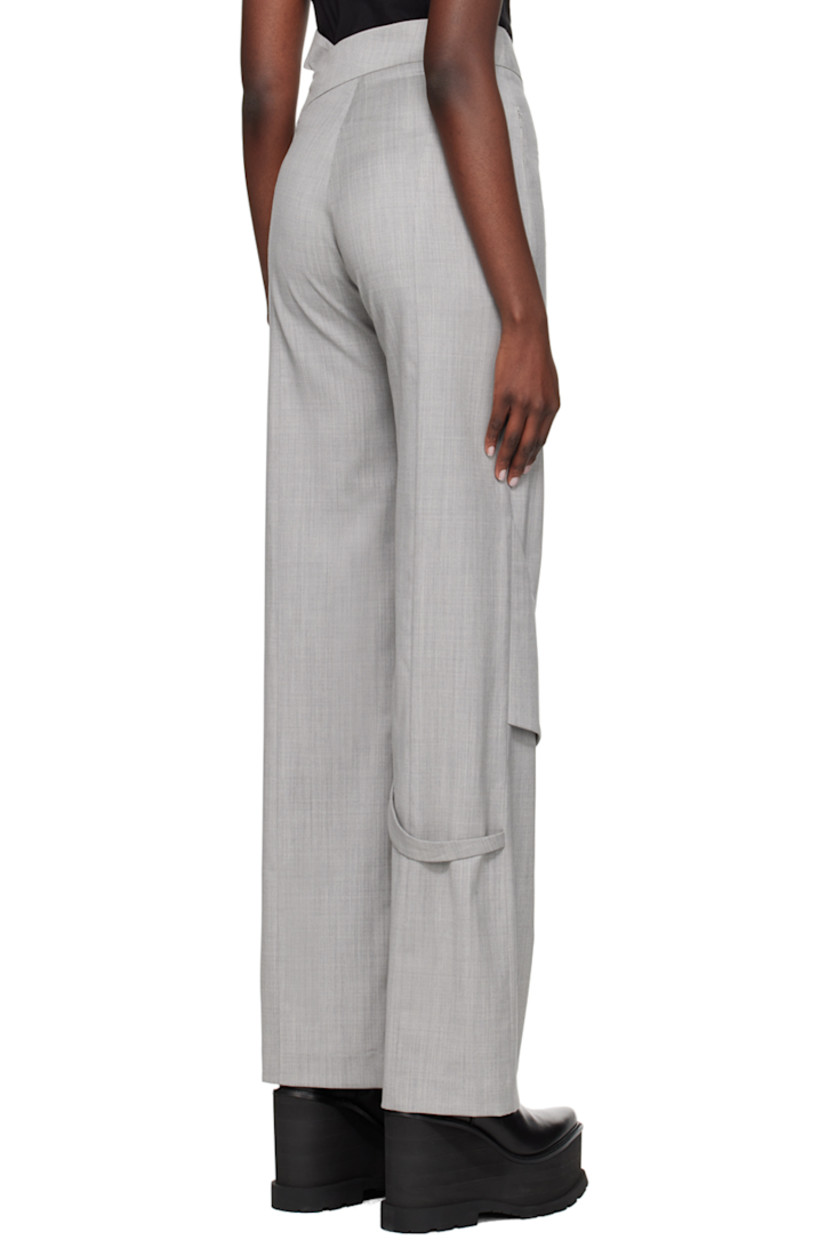 Wool delaine trousers.

· Strap at asymmetric waistband
· Two-pocket styling
· Zip-fly
· Fixed strap at front and back knee
· Concealed zip vent at cuffs

Supplier color: Light grey