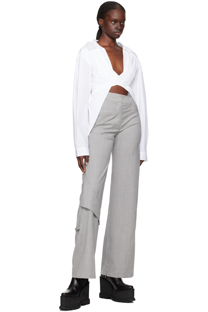 Wool delaine trousers.

· Strap at asymmetric waistband
· Two-pocket styling
· Zip-fly
· Fixed strap at front and back knee
· Concealed zip vent at cuffs

Supplier color: Light grey