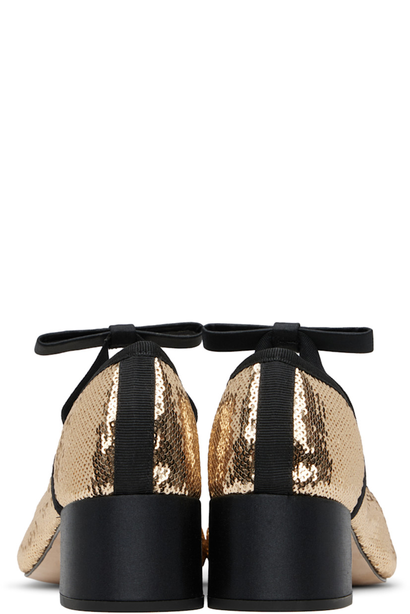 Sequinned plain-woven Mary Jane-style heels in gold tone.

· Grosgrain trim at collar
· Elasticized strap with bow accent at vamp
· Block heel with rubber injection
· Leather sole
· Heel: H1.75"

Supplier color: Bulle/Noir