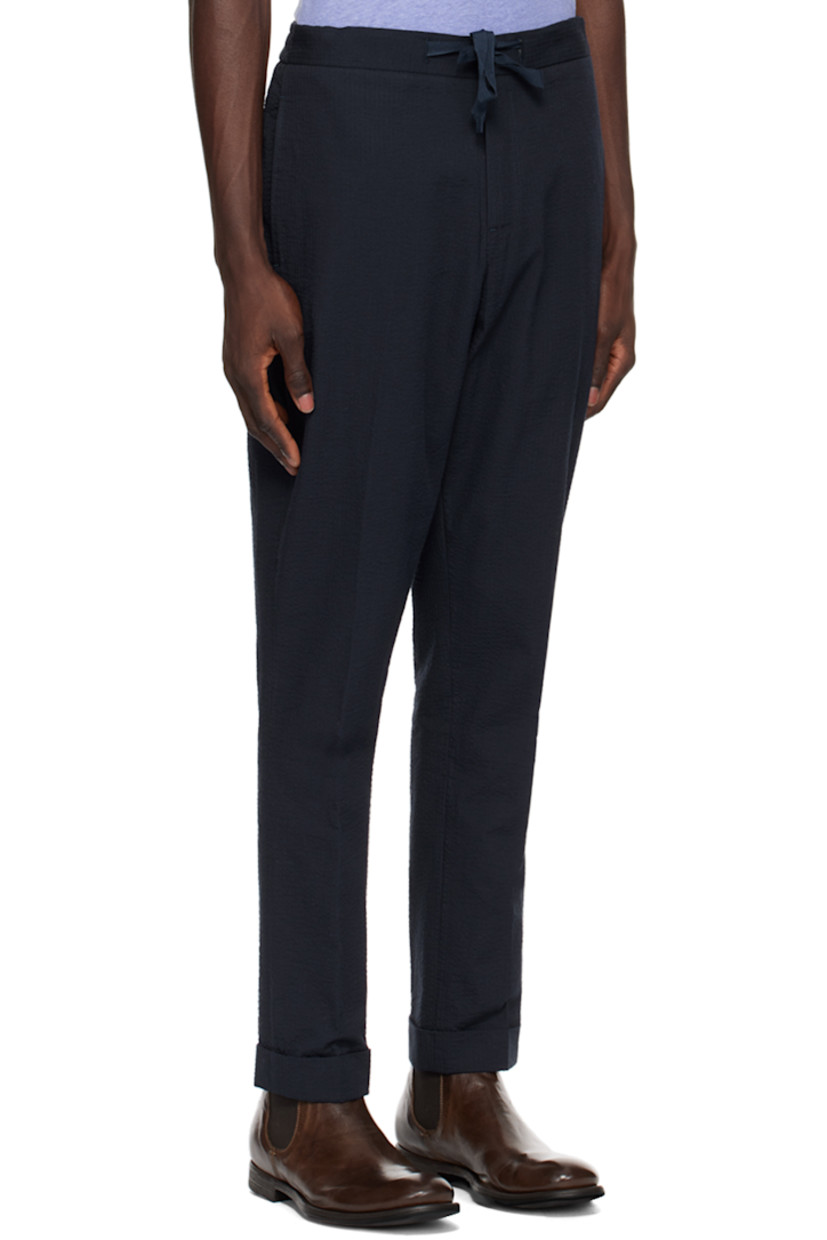 Loose-fit straight-leg reactive-dyed cotton seersucker trousers.

· Drawstring at partially elasticized waistband
· Four-pocket styling
· Zip-fly
· Creased legs

Supplier color: Navy