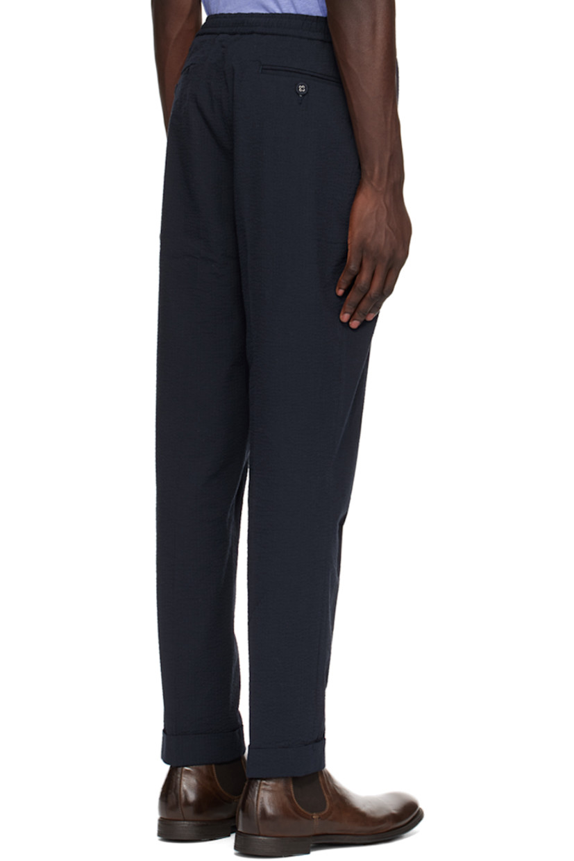 Loose-fit straight-leg reactive-dyed cotton seersucker trousers.

· Drawstring at partially elasticized waistband
· Four-pocket styling
· Zip-fly
· Creased legs

Supplier color: Navy