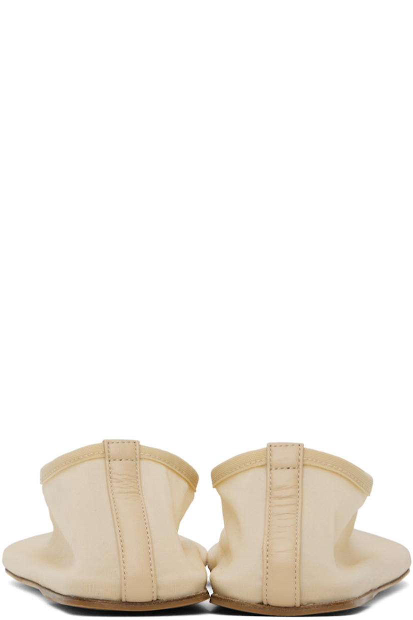 Semi-sheer nylon mesh slippers in beige.

· Central seam at vamp and heel counter
· Elasticized collar
· Logo embossed at padded footbed
· Nubuck and rubber sole

Supplier color: Butter