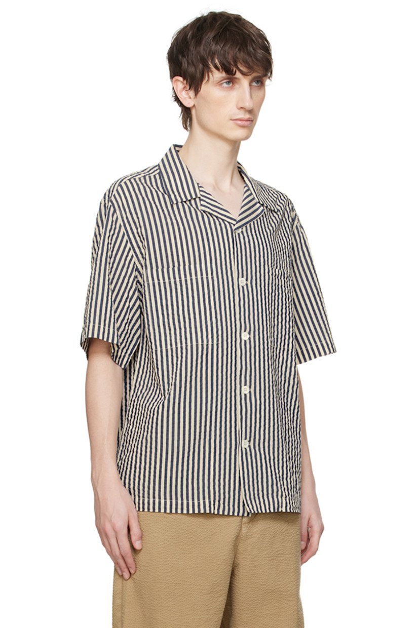 Handcrafted cotton- and silk-blend seersucker shirt. Stripes throughout.

· Open spread collar
· Button closure
· Patch pockets
· Shirttail hem
· Dropped shoulders

Supplier color: White/Navy