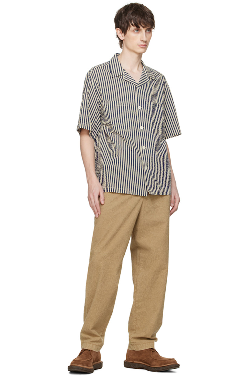 Handcrafted cotton- and silk-blend seersucker shirt. Stripes throughout.

· Open spread collar
· Button closure
· Patch pockets
· Shirttail hem
· Dropped shoulders

Supplier color: White/Navy
