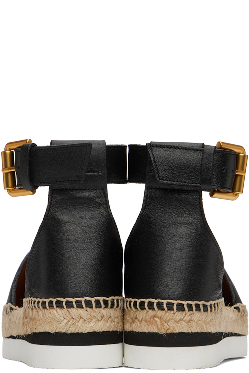 Grained calfskin espadrilles in black.

· Pin-buckle ankle strap
· Logo embossed at heel tab
· Logo embossed at padded leather footbed
· Suede and buffed leather lining
· Blanket stitching at welt
· Braided jute midsole
· Treaded foam rubber platform sole
· Platform: 1.25"

Supplier color: Black