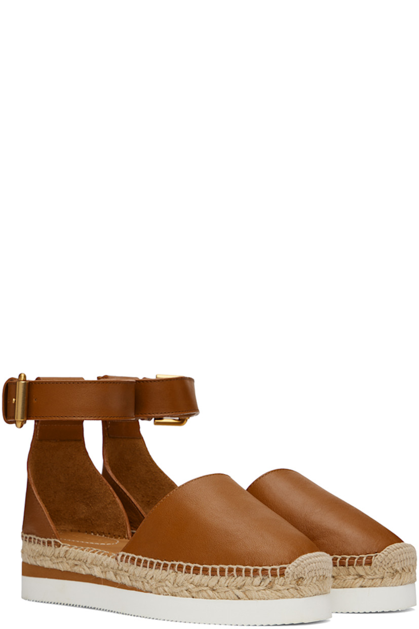 Grained calfskin espadrilles in tan.

· Pin-buckle ankle strap
· Logo embossed at heel tab
· Logo embossed at padded leather footbed
· Suede and buffed leather lining
· Blanket stitching at welt
· Braided jute midsole
· Treaded foam rubber platform sole
· Platform: 1.25"

Supplier color: Tan