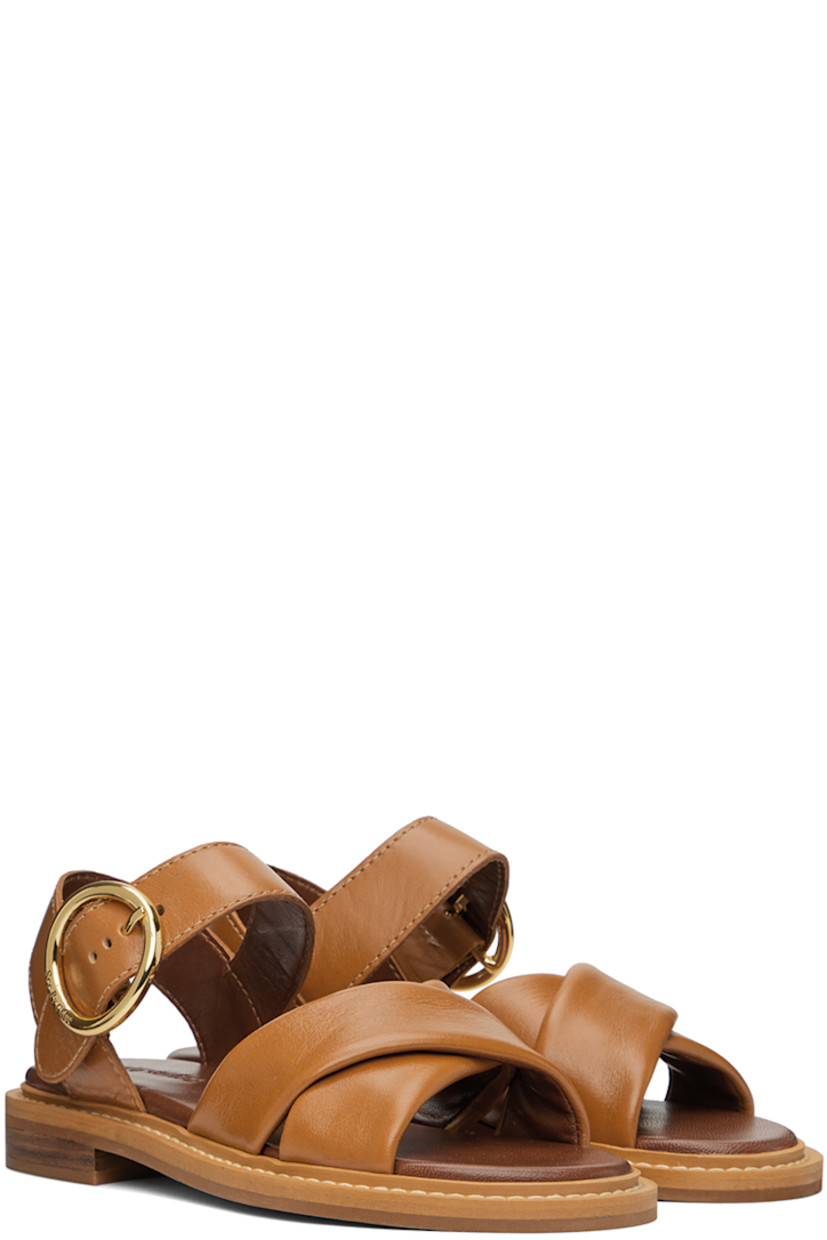 Buffed calfskin flat sandals in tan.

· Open toe
· Crisscrossing straps at vamp
· Pin-buckle ankle strap
· Logo-embossed padded grained leather footbed
· Buffed leather lining
· Topstitching at welt
· Stacked leather midsole
· Rubber sole
· Logo-engraved gold-tone hardware

Supplier color: Tan