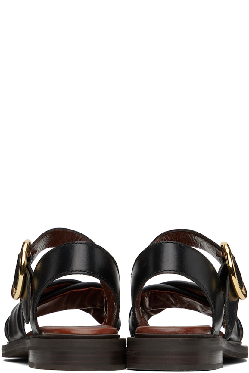 Buffed calfskin flat sandals in black.

· Open toe
· Padded criss-crossing straps at vamp
· O-ring pin-buckle ankle strap
· Logo embossed at grained leather footbed
· Topstitching in brown at welt
· Stacked leather heel
· Foam rubber sole
· Logo-engraved gold-tone hardware
· Heel: H1"

Supplier color: Black