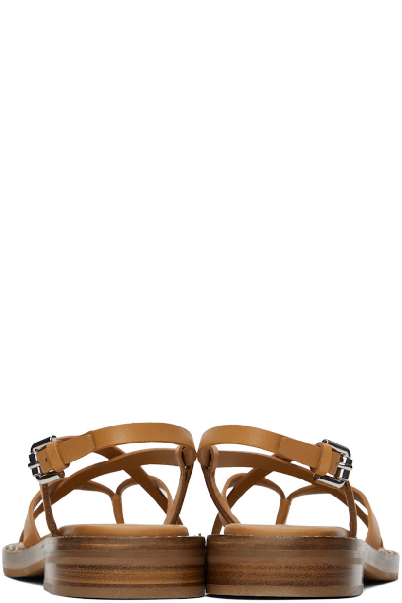 Buffed calfskin flat sandals in tan.

· Thong-style strap at open toe
· Criss-crossing straps at vamp
· Pin-buckle slingback strap
· Logo embossed at padded calfskin footbed
· Crystal-cut detailing at welt
· Stacked leather block heel with rubber injection
· Leather sole
· Heel: H1"

Supplier color: Tan