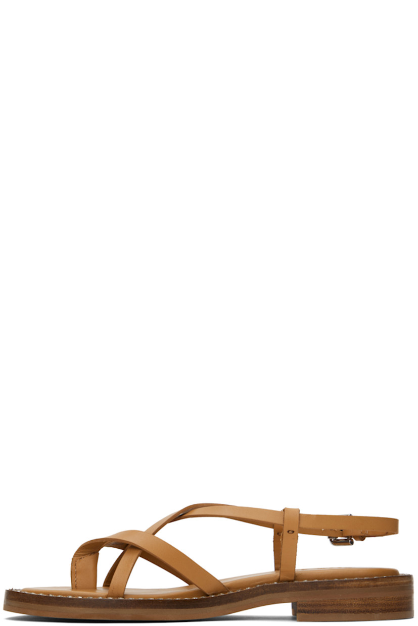 Buffed calfskin flat sandals in tan.

· Thong-style strap at open toe
· Criss-crossing straps at vamp
· Pin-buckle slingback strap
· Logo embossed at padded calfskin footbed
· Crystal-cut detailing at welt
· Stacked leather block heel with rubber injection
· Leather sole
· Heel: H1"

Supplier color: Tan