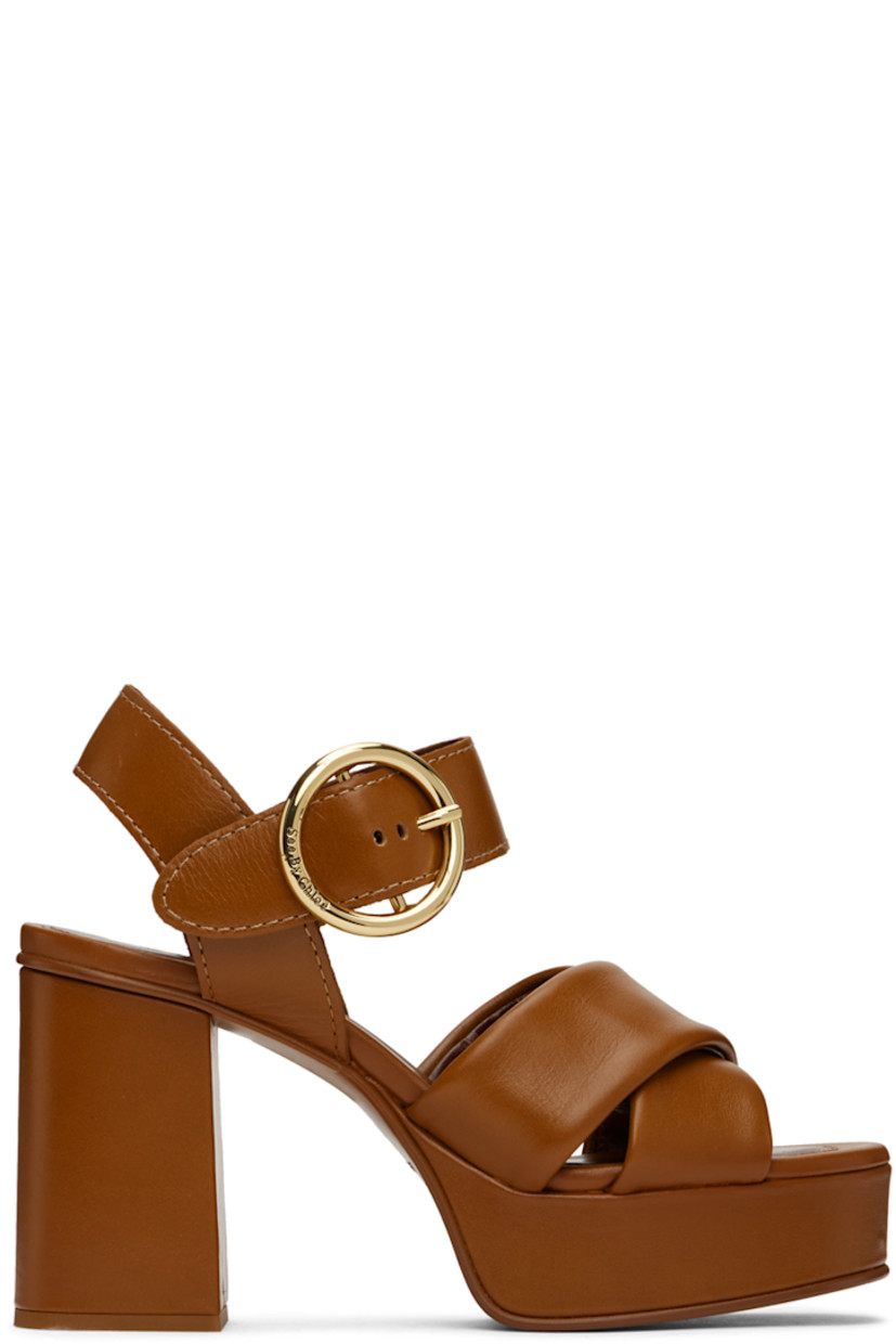 Grained calfskin heeled sandals in tan.

· Open toe
· Criss-crossing straps at vamp
· Pin-buckle ankle strap
· Covered block heel with rubber injection
· Covered platform midsole
· Leather sole with rubber injection
· Platform: H1"
· Heel: H3.5"

Supplier color: Tan