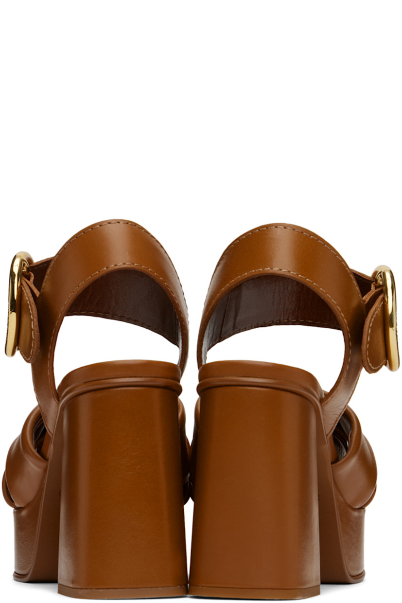 Grained calfskin heeled sandals in tan.

· Open toe
· Criss-crossing straps at vamp
· Pin-buckle ankle strap
· Covered block heel with rubber injection
· Covered platform midsole
· Leather sole with rubber injection
· Platform: H1"
· Heel: H3.5"

Supplier color: Tan