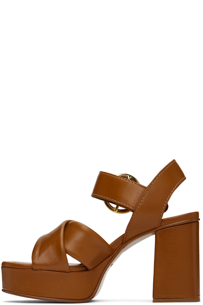 Grained calfskin heeled sandals in tan.

· Open toe
· Criss-crossing straps at vamp
· Pin-buckle ankle strap
· Covered block heel with rubber injection
· Covered platform midsole
· Leather sole with rubber injection
· Platform: H1"
· Heel: H3.5"

Supplier color: Tan