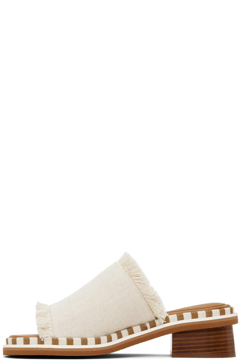 Fringed canvas slip-on heeled sandals in off-white. 

· Open toe
· Logo embossed at molded calfskin footbed
· Striped canvas trim at welt
· Stacked leather heel with rubber injection
· Crepe rubber sole

Supplier color: Natural