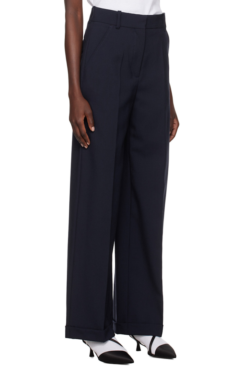 Virgin wool trousers.

· Belt loops 
· Four-pocket styling 
· Zip-fly 
· Creased legs 
· Logo patch at back 

Supplier color: Midnight blue