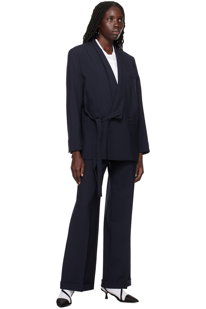 Virgin wool trousers.

· Belt loops 
· Four-pocket styling 
· Zip-fly 
· Creased legs 
· Logo patch at back 

Supplier color: Midnight blue