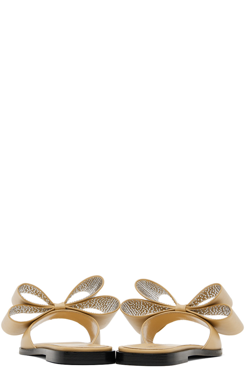 Nappa leather flat sandals in beige. 

· Open square toe 
· Bow with crystal-cut accents at vamp
· Logo stamp at grained leather footbed
· Suede sole with rubber injection

Supplier color: Beige