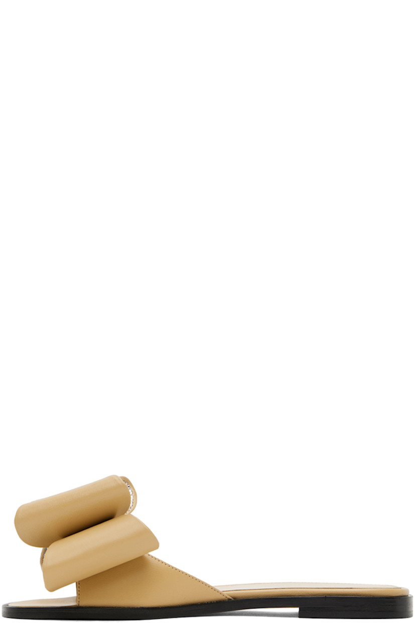 Nappa leather flat sandals in beige. 

· Open square toe 
· Bow with crystal-cut accents at vamp
· Logo stamp at grained leather footbed
· Suede sole with rubber injection

Supplier color: Beige