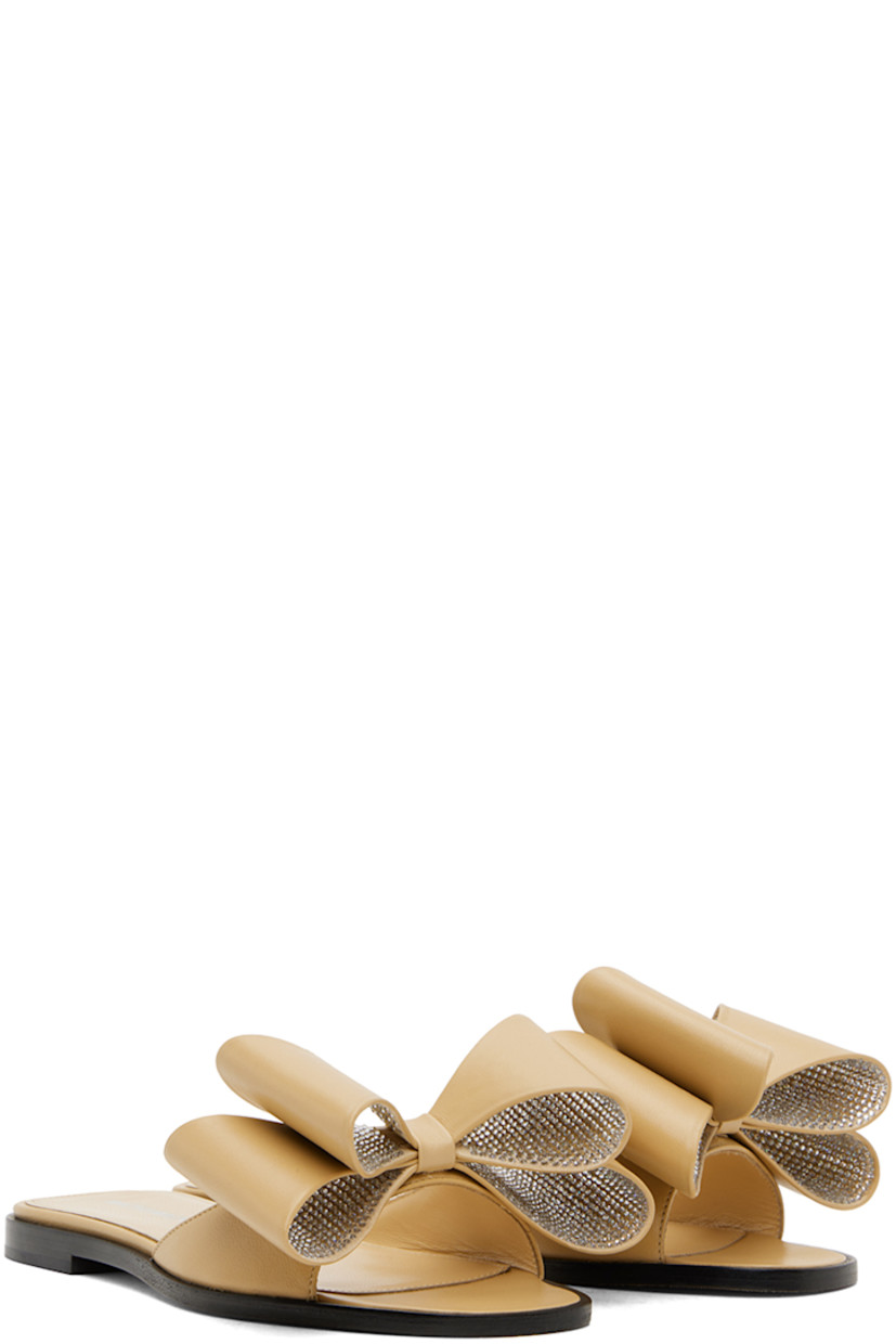 Nappa leather flat sandals in beige. 

· Open square toe 
· Bow with crystal-cut accents at vamp
· Logo stamp at grained leather footbed
· Suede sole with rubber injection

Supplier color: Beige