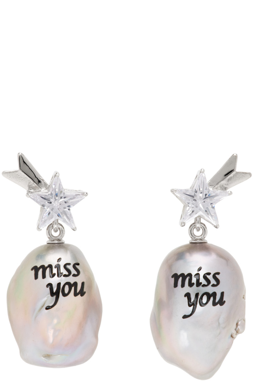 Pair of drop earrings in rhodium-plated brass.

· Graphic with cubic zirconia at face
· Baroque freshwater pearl with printed text
· Post-stud fastening
· H1.5" x W0.75"

Supplier color: White