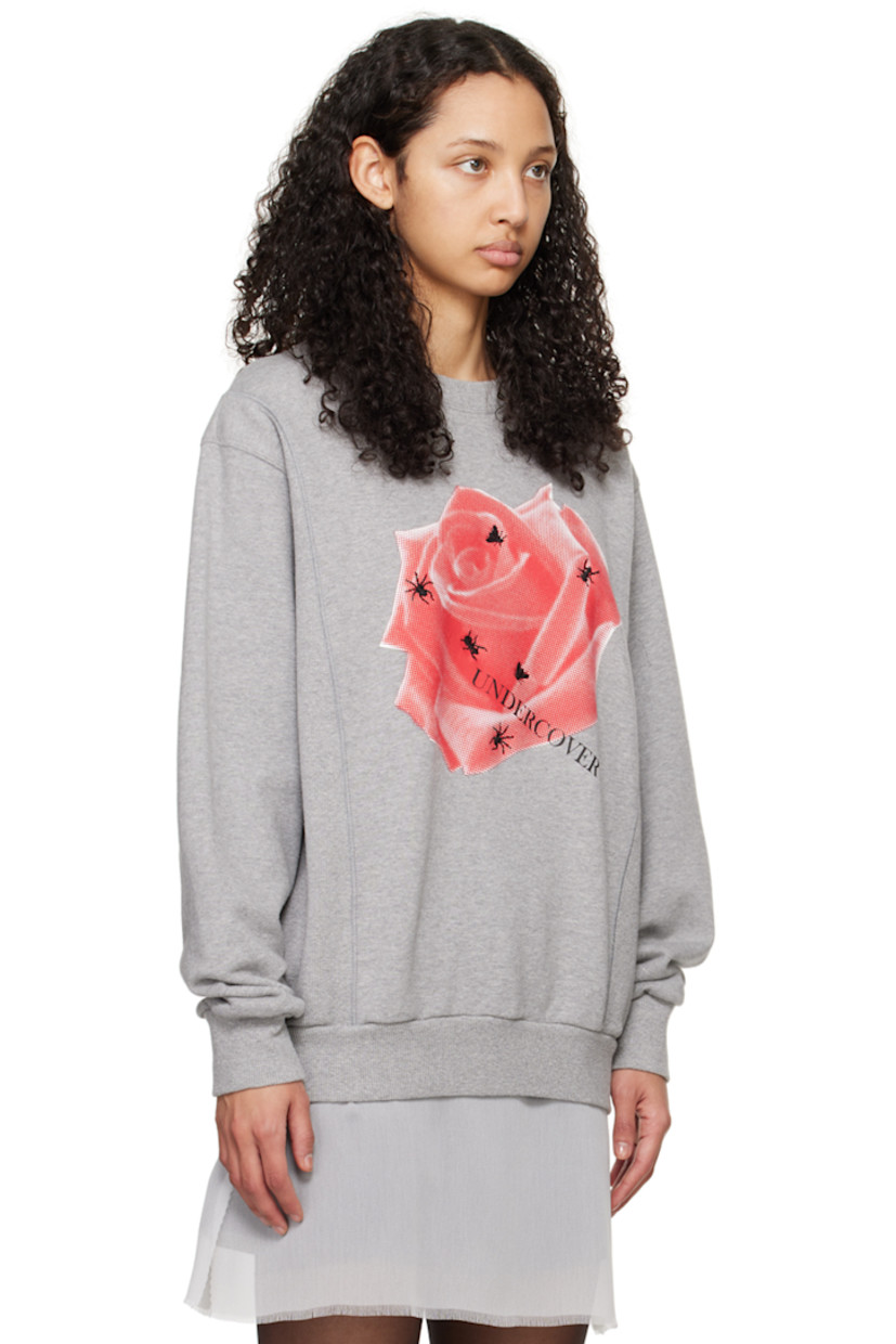 French terry and rib knit sweatshirt. 

· Paneled construction
· Rib knit crewneck, hem, and cuffs
· Floral graphic and logo printed at front 
· Graphic embroidered at front 

Supplier color: Top gray