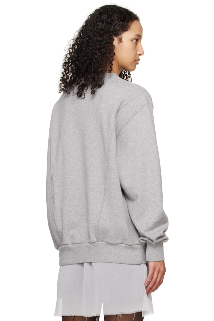 French terry and rib knit sweatshirt. 

· Paneled construction
· Rib knit crewneck, hem, and cuffs
· Floral graphic and logo printed at front 
· Graphic embroidered at front 

Supplier color: Top gray