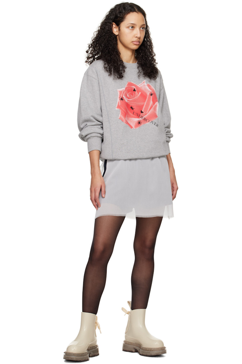 French terry and rib knit sweatshirt. 

· Paneled construction
· Rib knit crewneck, hem, and cuffs
· Floral graphic and logo printed at front 
· Graphic embroidered at front 

Supplier color: Top gray