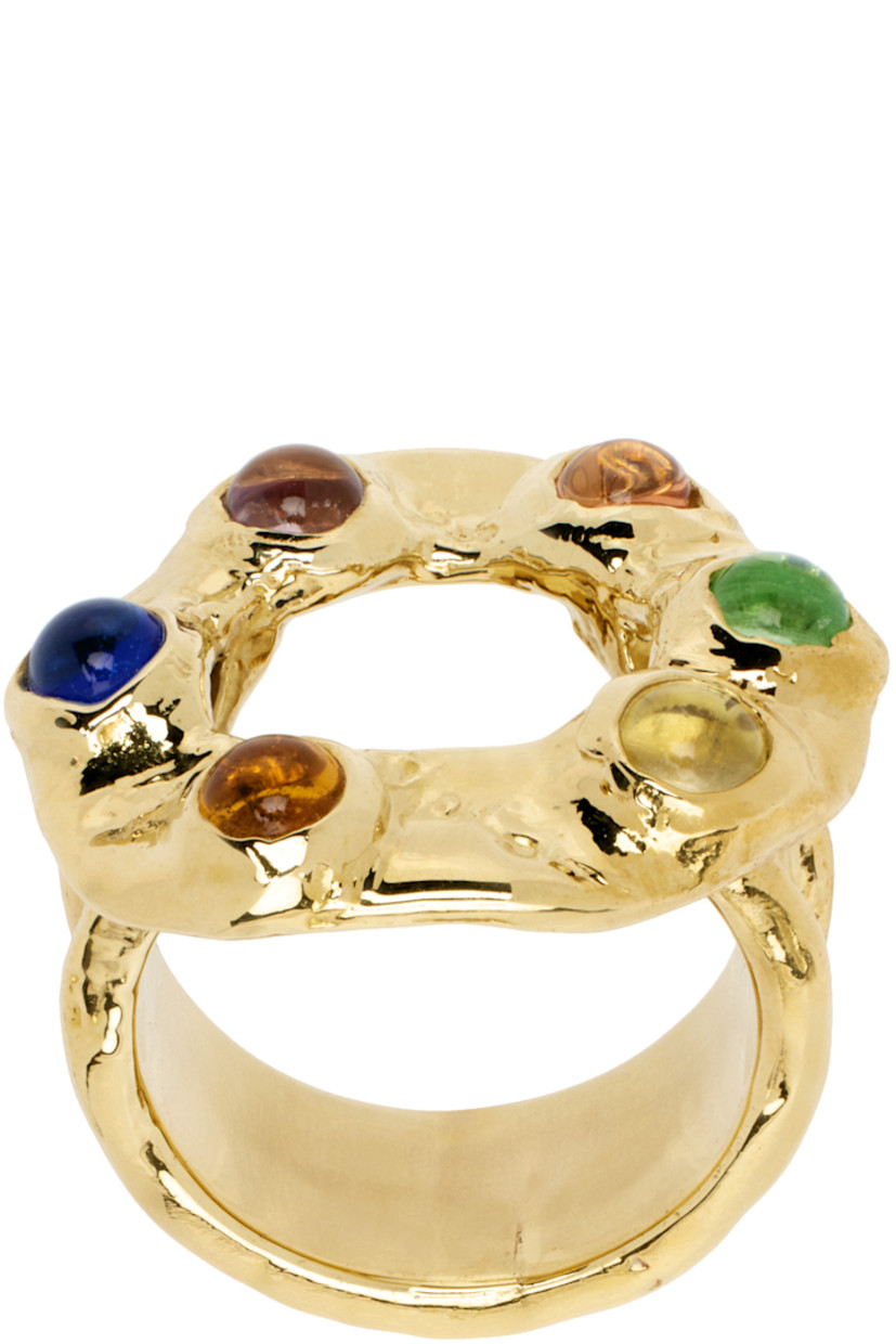 Hammered band ring in gold-tone brass. 

· Cabochons glass stones at face
· Logo engraved at inner band

Supplier color: Multi