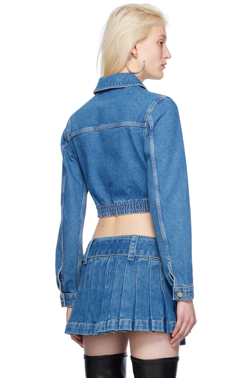 Heavyweight garment-dyed non-stretch denim jacket.

· Spread collar
· Hook-eye closure
· Flap pockets
· Boning at partially elasticized corset-style hem
· Single-button barrel cuffs
· Contrast stitching in tan

Supplier color: American blue