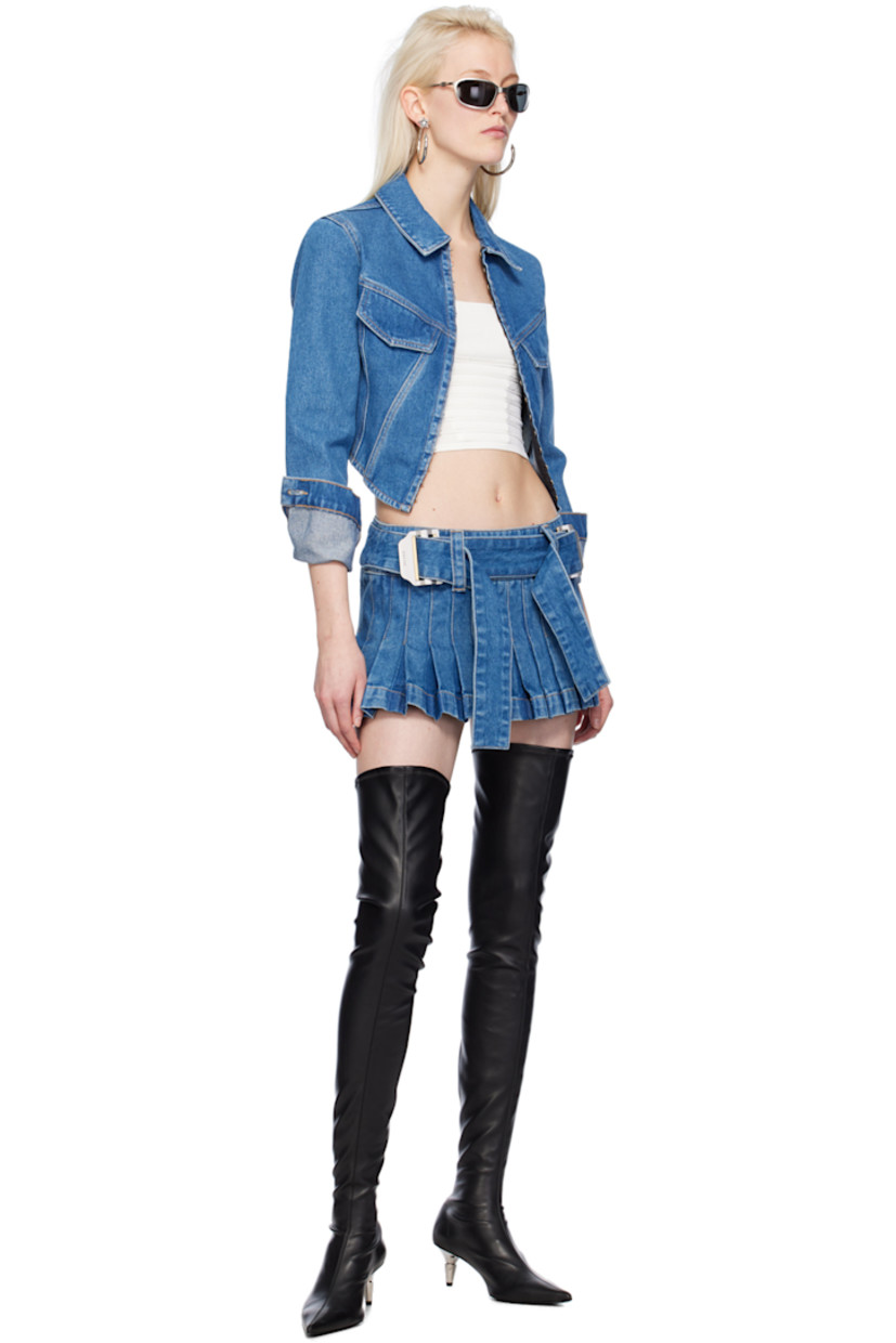 Heavyweight garment-dyed non-stretch denim jacket.

· Spread collar
· Hook-eye closure
· Flap pockets
· Boning at partially elasticized corset-style hem
· Single-button barrel cuffs
· Contrast stitching in tan

Supplier color: American blue