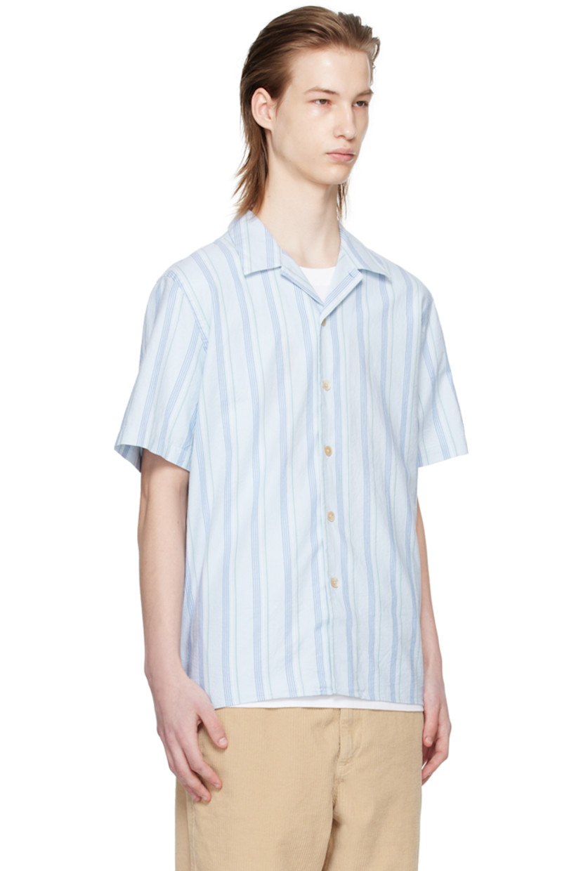 Basket-woven GOTS-certified organic cotton shirt. Stripes throughout. 

· Open spread collar 
· Button closure 
· Tennis-tail hem 
· Logo flag at side seam 

Supplier color: Light blue