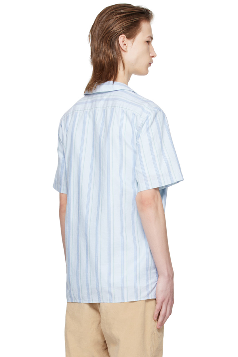 Basket-woven GOTS-certified organic cotton shirt. Stripes throughout. 

· Open spread collar 
· Button closure 
· Tennis-tail hem 
· Logo flag at side seam 

Supplier color: Light blue