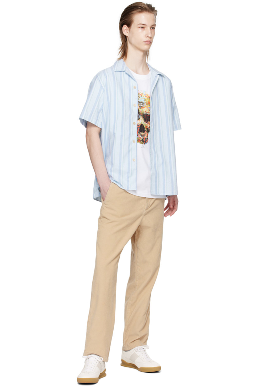 Basket-woven GOTS-certified organic cotton shirt. Stripes throughout. 

· Open spread collar 
· Button closure 
· Tennis-tail hem 
· Logo flag at side seam 

Supplier color: Light blue