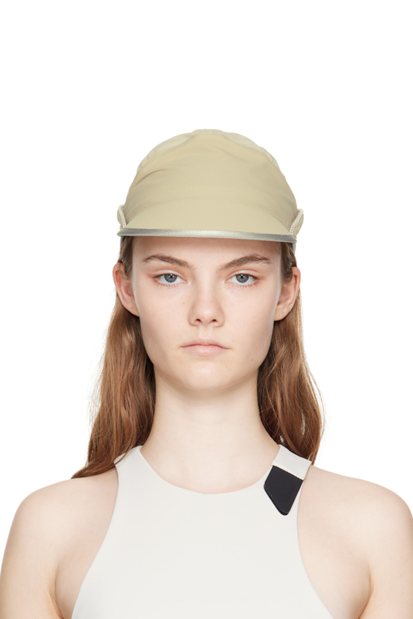 Polyester ripstop and crepe cap in beige.

· Paneled and layered construction 
· Mesh piping at crown 
· Curved brim
· Adjustable press-release strap at back
· Grosgrain browband 
· Partial mesh lining 

Supplier color: Beige