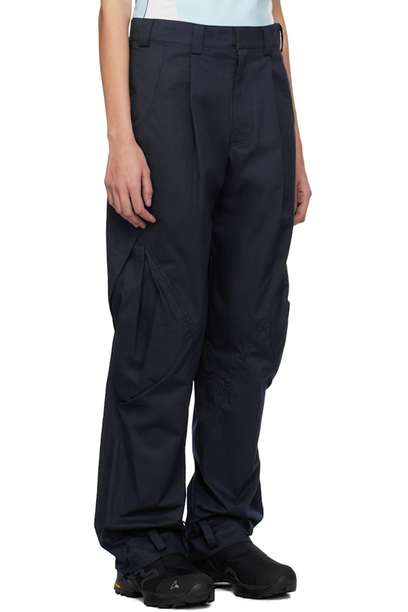 Cotton twill trousers. 

· Paneled construction
· Belt loops
· Four-pocket styling
· Zip-fly
· Pleats at front
· Loops and press-stud fastening at cuffs 
· Flap pocket at outseams 

Supplier color: Navy