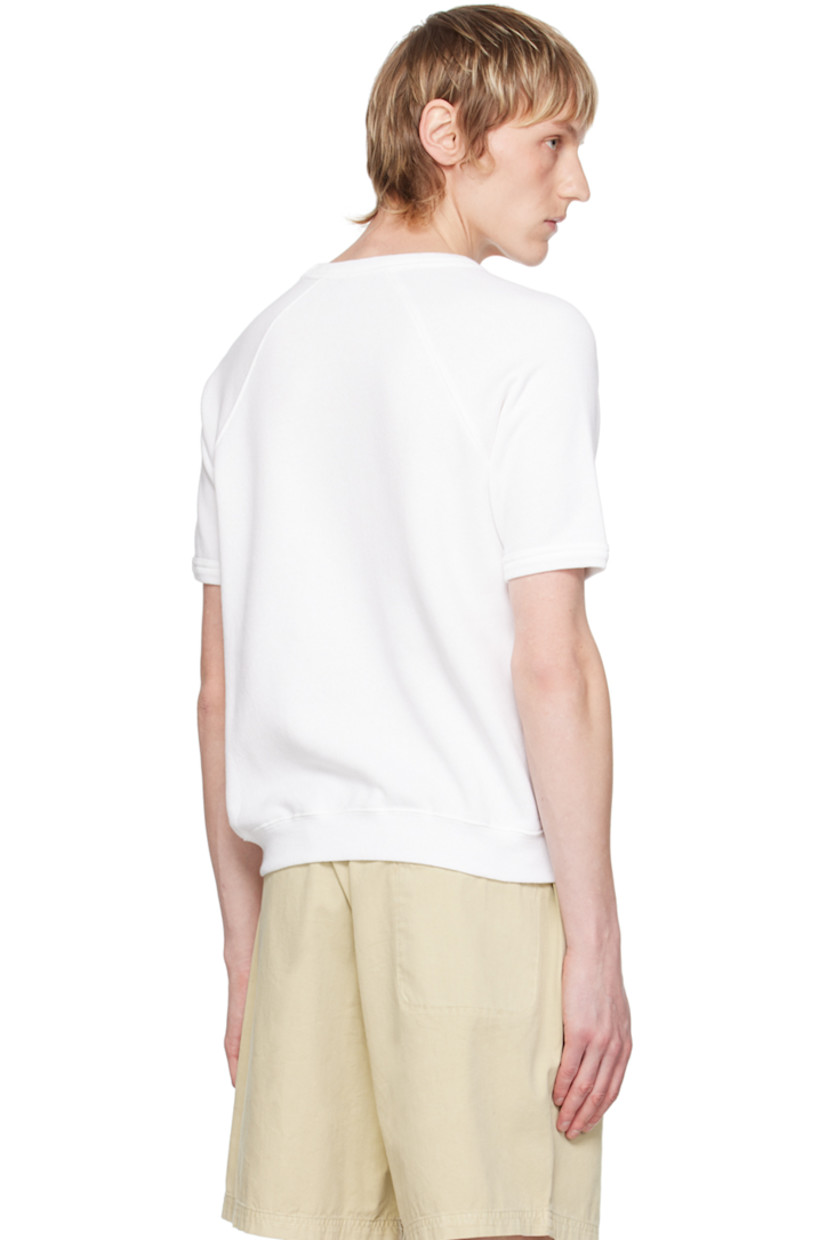 Pre-shrunk cotton- and polyester-blend fleece T-shirt. 

· Rib knit crewneck, hem, and cuffs
· Text and logo printed at front 
· Raglan sleeves

Supplier color: White/Verde