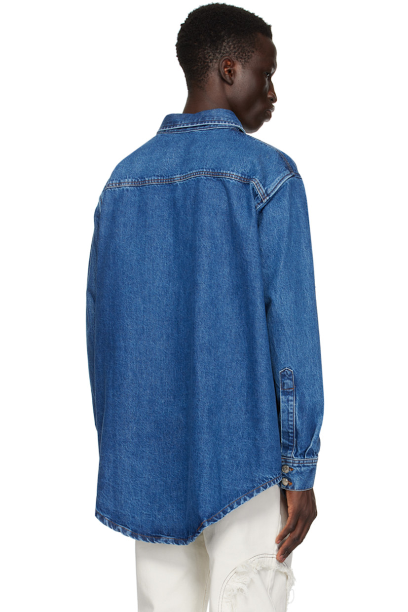 Non-stretch recycled cotton-blend denim shirt. 

· Spread collar
· Button closure
· Frayed edges at front
· Shirttail hem
· Two-button barrel cuffs
· Contrast stitching in tan 

Supplier color: Blue