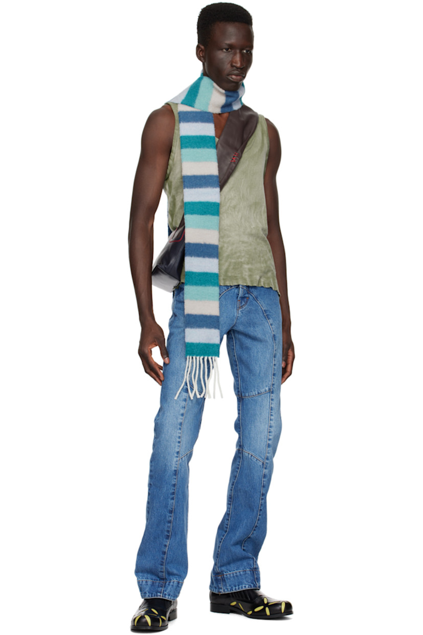 Cotton jersey tank top. Fading throughout. 

· Scoop neck 
· Raw edges at hem 

Supplier color: Washed light khaki