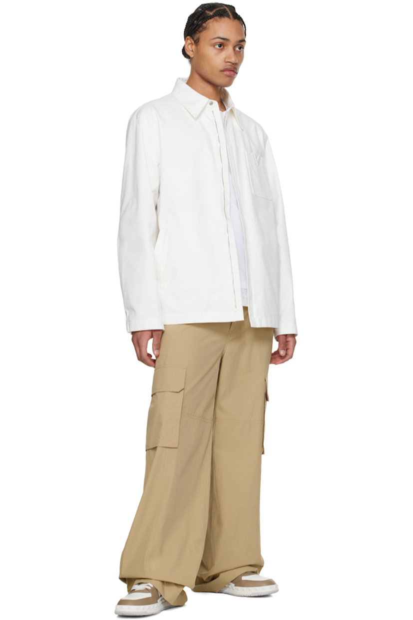 Stretch cotton canvas jacket. 

· Spread collar
· Zip closure
· Logo hardware at chest
· Patch and welt pockets
· Adjustable press-stud fastening at cuffs
· Patch pocket at interior
· Full cotton poplin lining

Supplier color: Avorio