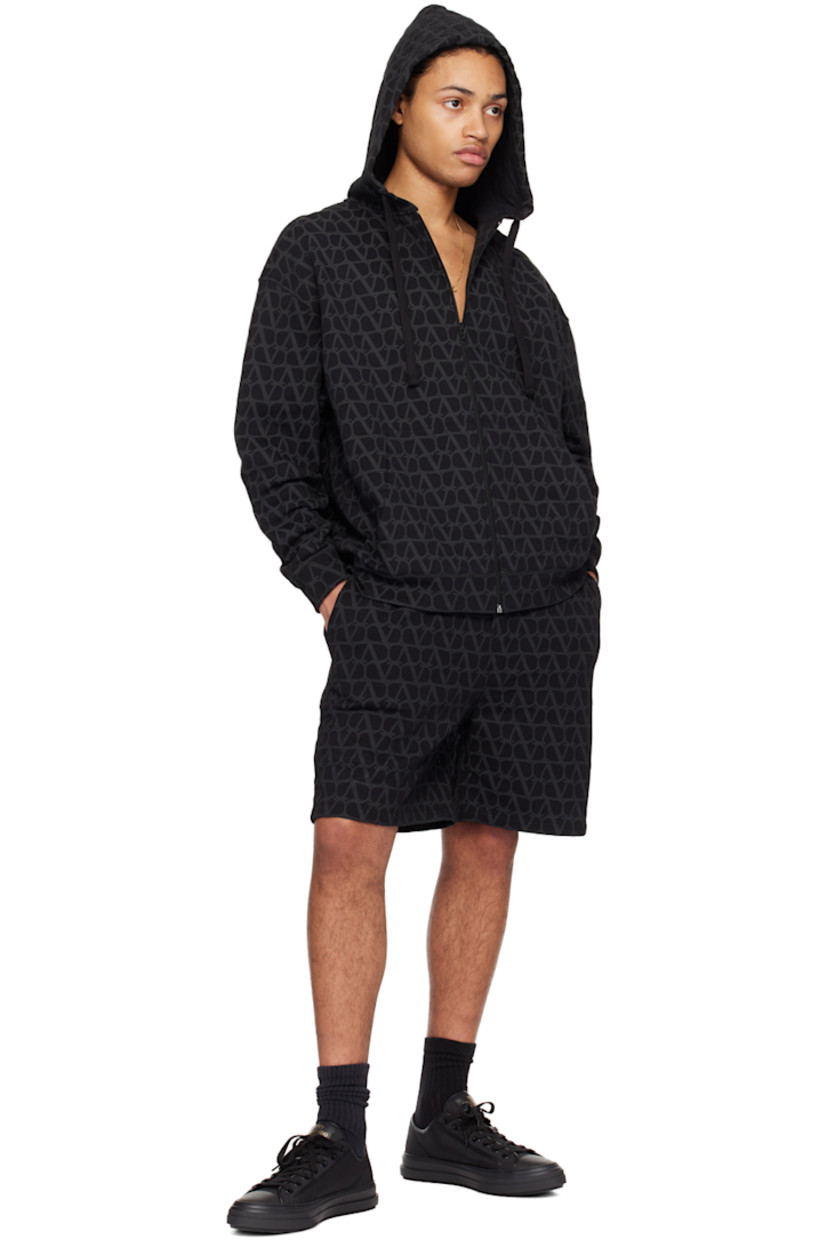 Cotton fleece hoodie. Logo pattern printed throughout. 

· Drawstring at hood
· Zip closure
· Kangaroo pocket 
· Rib knit hem and cuffs 
· Dropped shoulders 

Supplier color: Toile icono nero