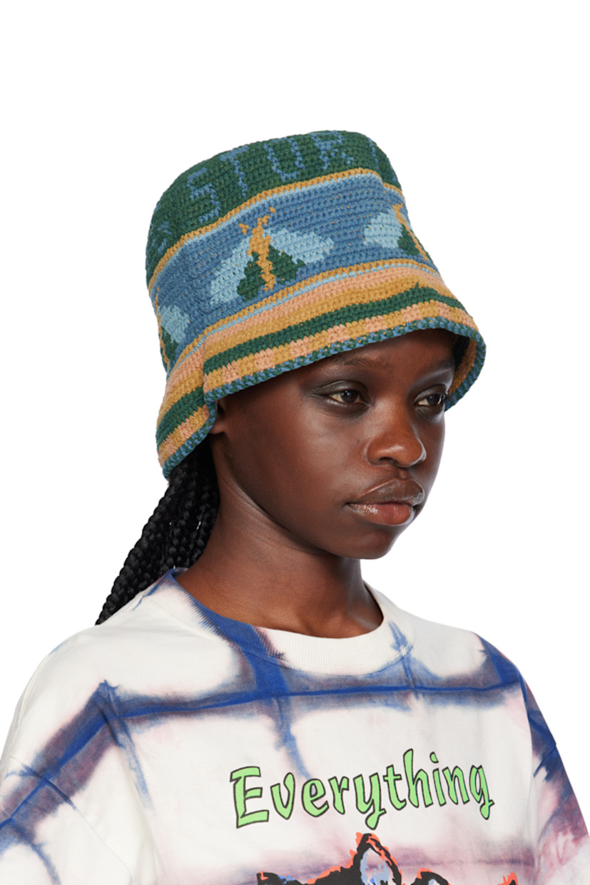 Hand-dyed and hand-crocheted organic cotton beach hat in blue, orange, and green. Intarsia logo, graphics, and stripes throughout.

Supplier color: Indigo moth