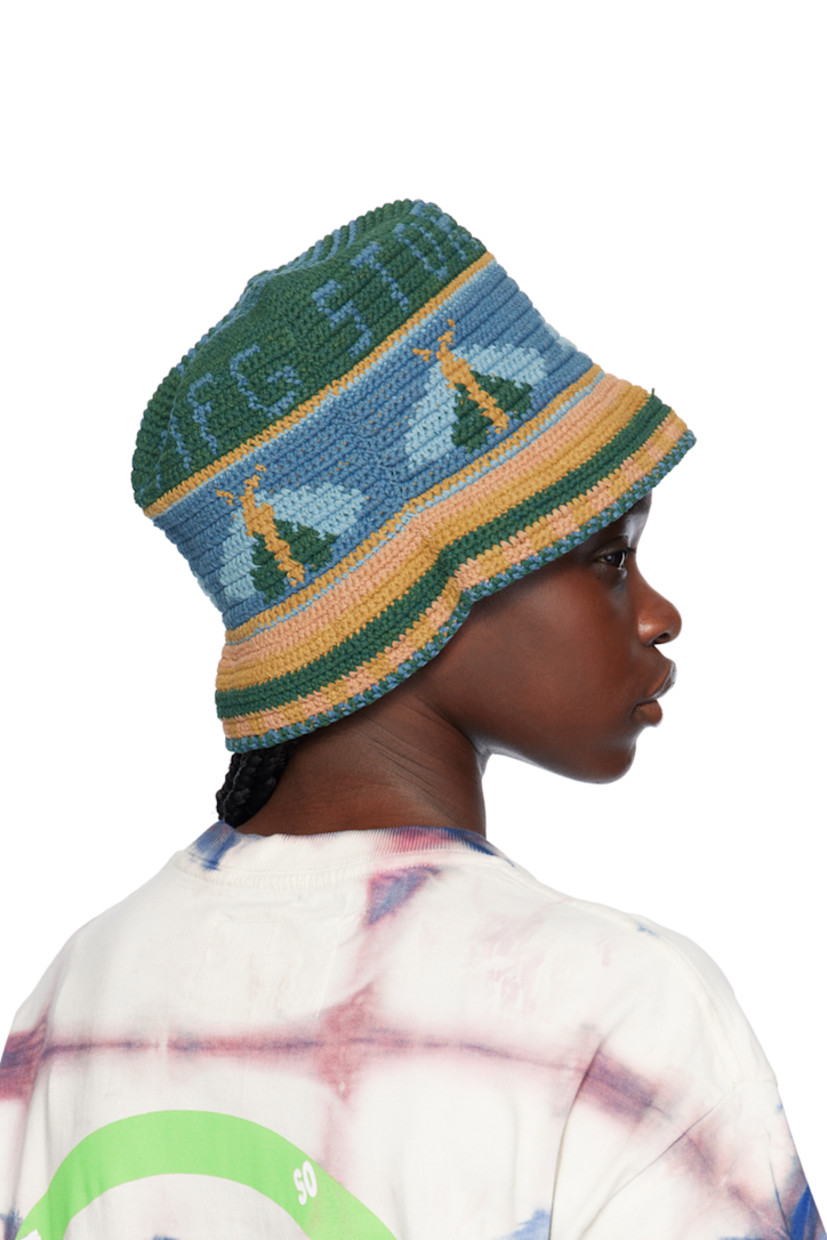Hand-dyed and hand-crocheted organic cotton beach hat in blue, orange, and green. Intarsia logo, graphics, and stripes throughout.

Supplier color: Indigo moth
