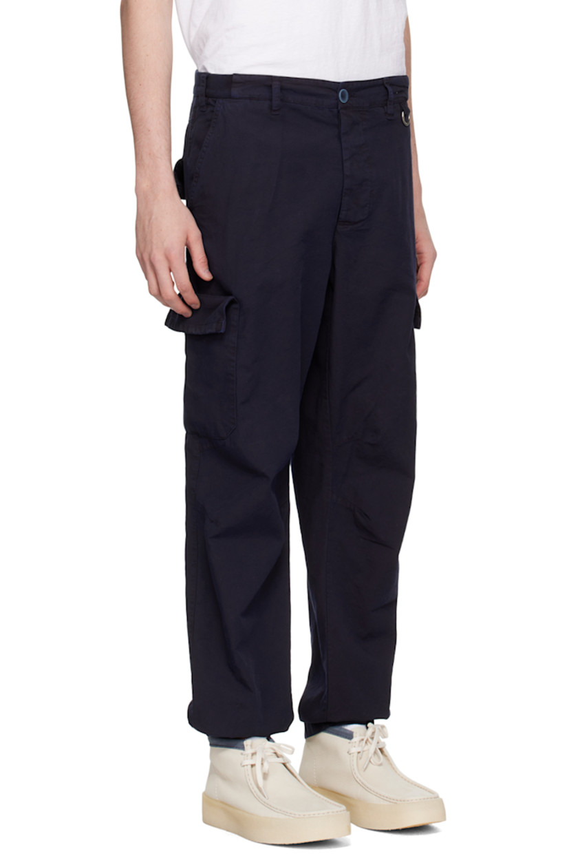 Cotton canvas cargo pants. 

· Belt loops
· Partial rib knit trim at waistband 
· Four-pocket styling 
· Button-fly
· D-ring at front
· Darts at knees
· Partially elasticized cuffs
· Cargo pockets at outseams

Supplier color: Navy