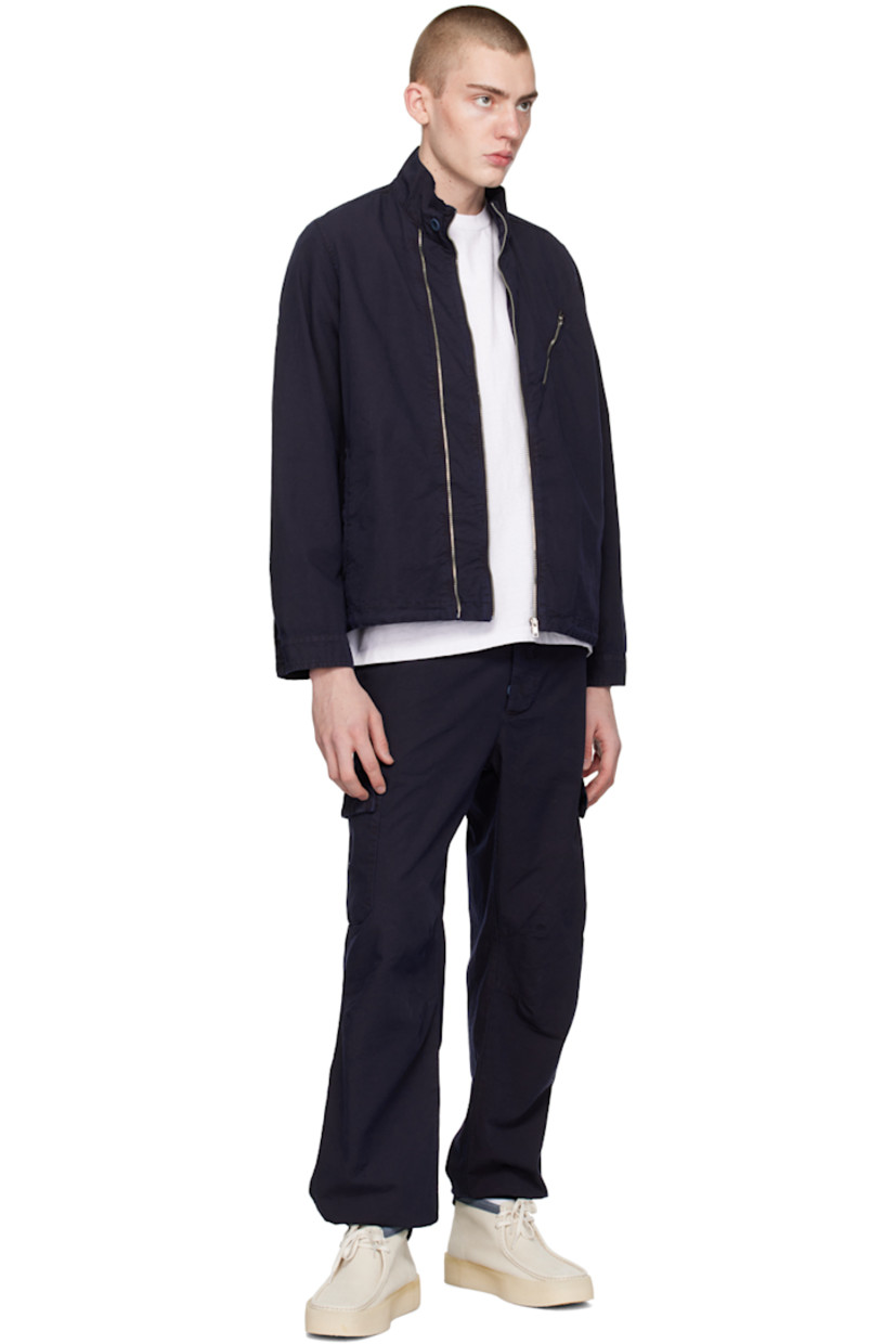 Cotton canvas cargo pants. 

· Belt loops
· Partial rib knit trim at waistband 
· Four-pocket styling 
· Button-fly
· D-ring at front
· Darts at knees
· Partially elasticized cuffs
· Cargo pockets at outseams

Supplier color: Navy