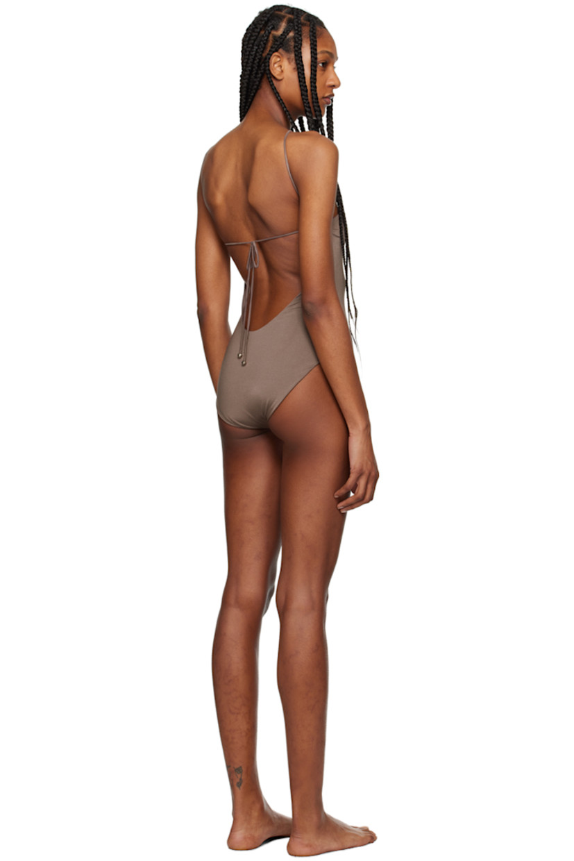 XTRA LIFE™ stretch ECONYL® nylon jersey one-piece swimsuit.

· O-ring at halter neck
· Fixed shoulder straps
· Self-tie fastening at back
· Fully lined
· Silver-tone hardware

Supplier color: Brown